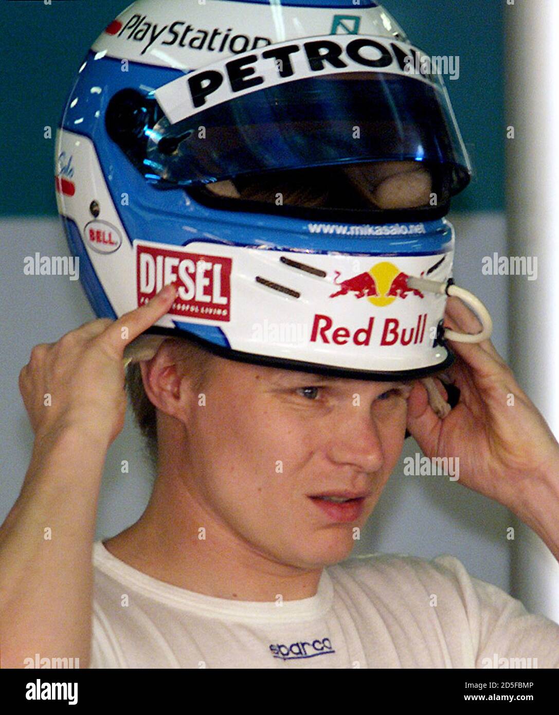 Sauber driver Mika Salo from Finland tries his new helmet before practice  at Melbourne's Albert Park Grand Prix circuit March 10. Salo was 11t  fastest after two practice sessions with a time