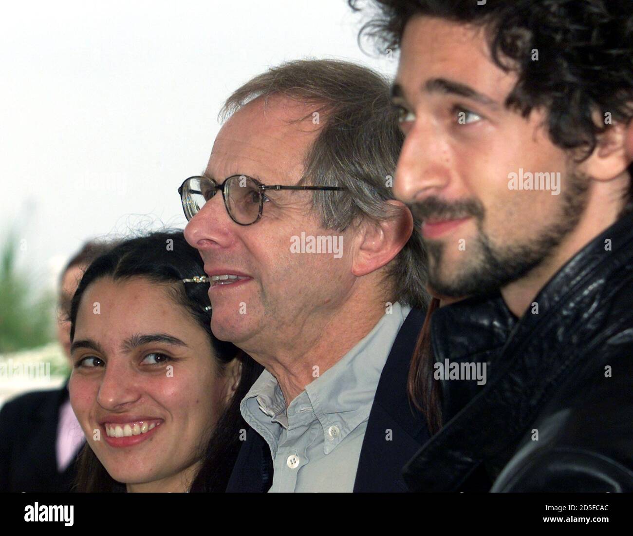 British director Ken Loach (C) stands between Mexican actress Pilar Padilla  (L) and American actor Adrien Brody (R) during a photo call, May 11. Loach's  film "Bread and Roses" is screened in