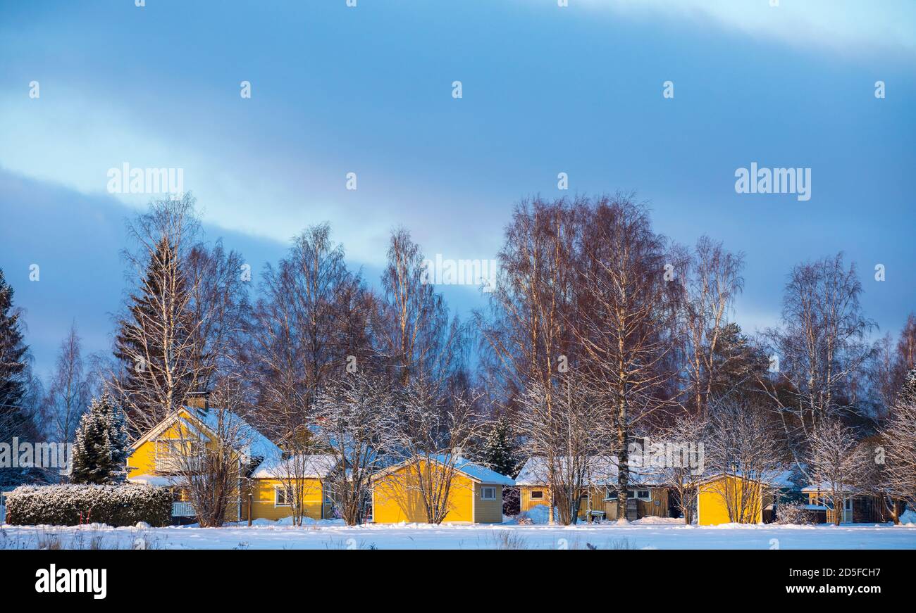 View of yellow wooden detached house and appendages at Winter , Finland Stock Photo