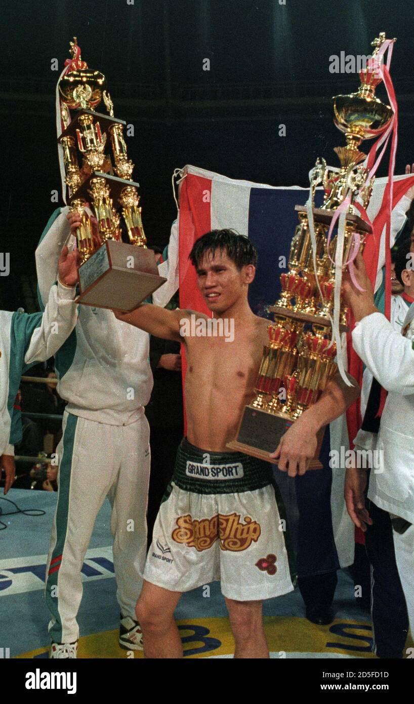 Chitalada Of Thailand Holds Trophies After Retaining Wbc Flightweight Title Over South Korean Jung Koo In Seoul Thailand S Sot Chitalada Holds His Trophies After Retaining His Wbc Flyweight Title With A Narrow 12 Round