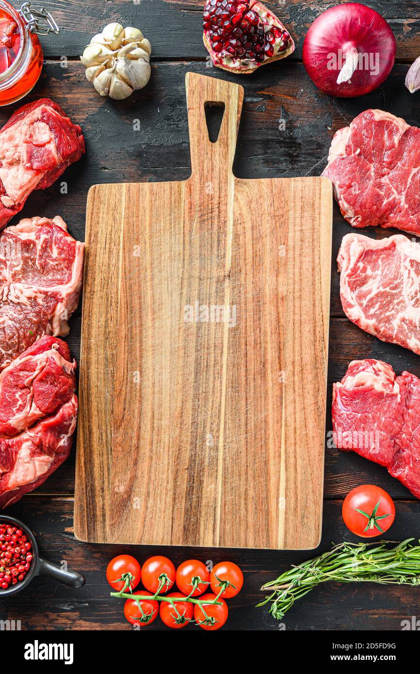 Meat beef steaks frame concept, with different steak cuts andempty chopping  board in frame on dark old wooden table top view Stock Photo - Alamy