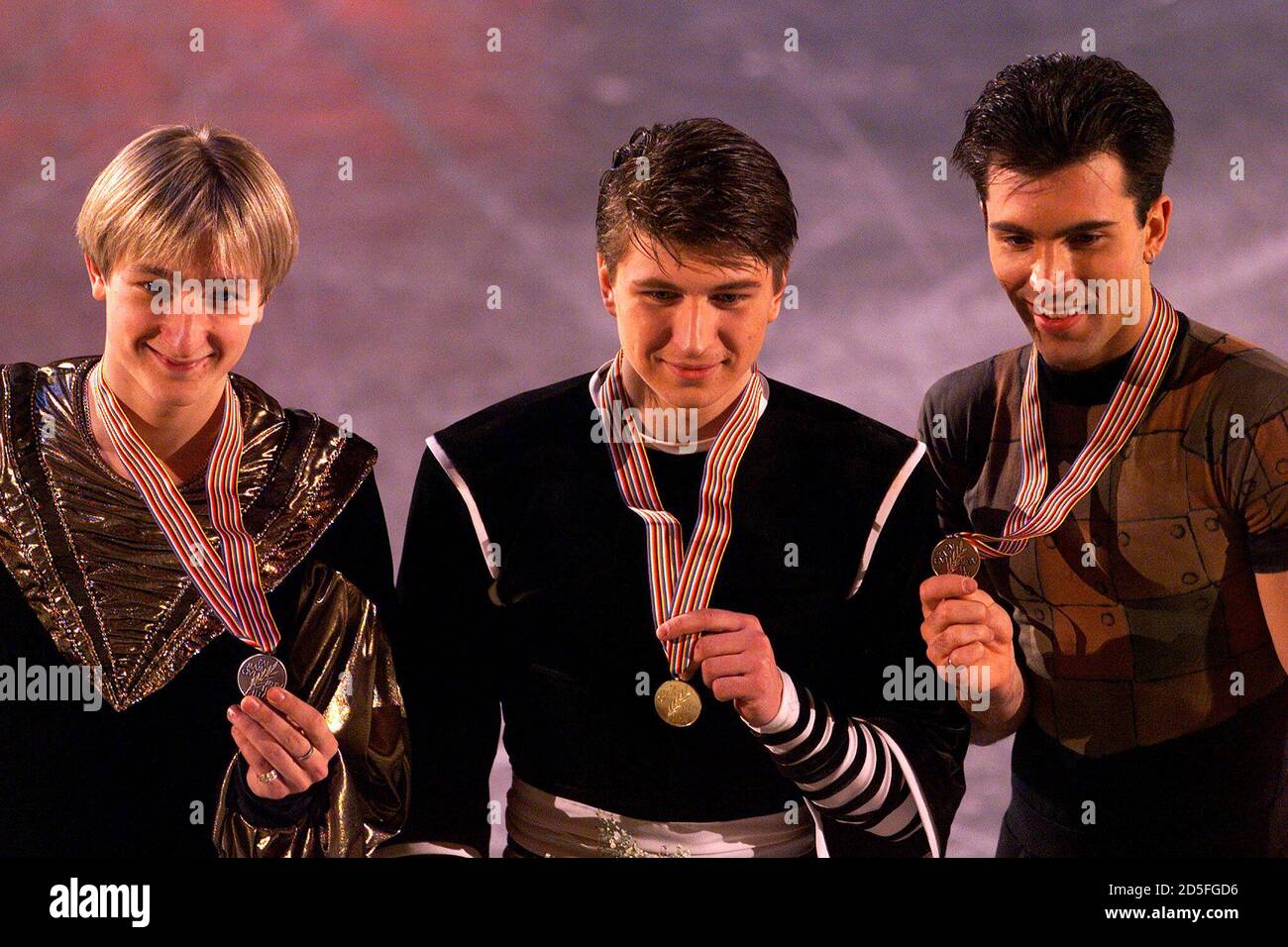 Russia's Alexei Yagudin (C), compatriot Evgeny Plushenko (L) and USA's  Michael Weiss display their medals at the end of competition for the men's  World Championships for figure skating March 25. Yagudin took