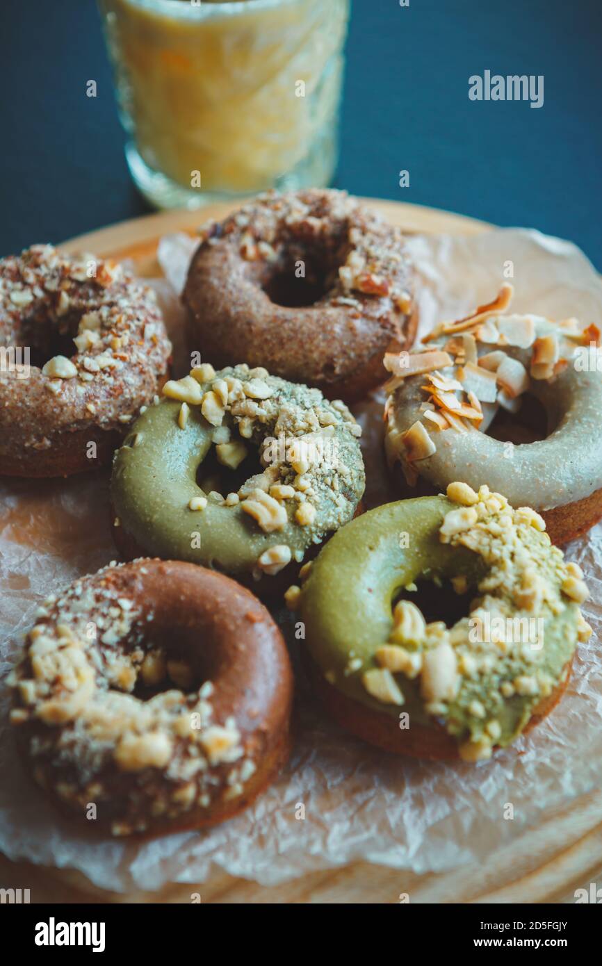 Fresh baked pistachio donuts with nuts.Doughnuts in bakery acfe.Sweet