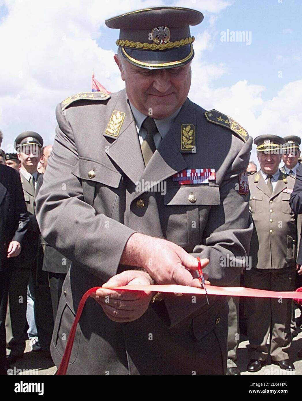 Yugoslav Army Chief of Staff General Dragoljub Ojdanic cuts the ribbon to  officially open the pontoon bridge over the Velika Morava river, on the  Belgrade-Nis highway near the central Serbian town of