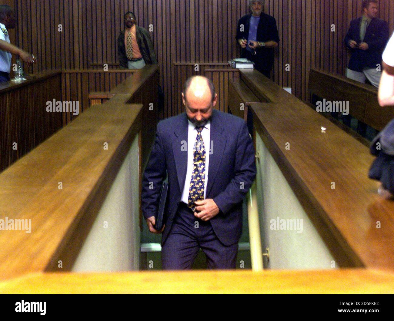 Wouter Basson, a 49-year-old cardiologist, who still operates at the South African army's Pretoria hospital, goes to talk with his lawyers October 6, during a break in his court appearance where he is facing 64 charges ranging from drug dealing to more than 200 murders.  Basson is a military surgeon dubbed 'Doctor Death' for his apartheid era germ and chemical warfare campaign against blacks.  ??» Stock Photo