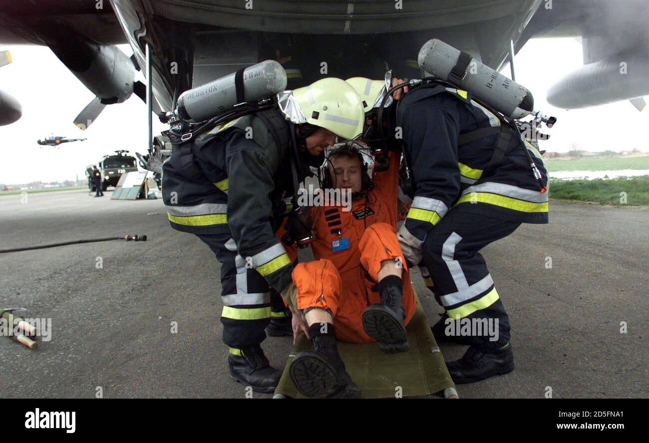 A volunteer playing the role of an injured man is evacuated by firemen during the reconstruction of an emergency plan set up after an aeroplane crash in Koksijde, northern Belgium March 14. These exercises are frequently organised to prevent mistakes in the evacuation of victims.  HRM Stock Photo