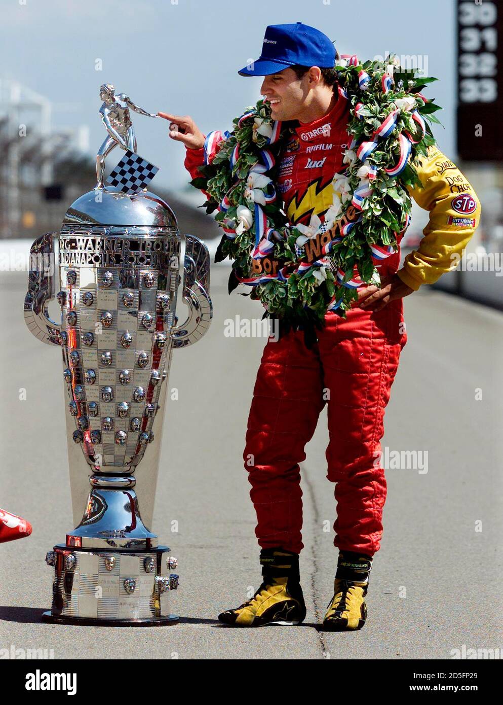 Indianapolis 500 winner Juan Montoya from Colombia stands next to the  Borg-Warner trophy during a photo session on the main straightaway at the  Indianapolis Motor Speedway May 29. Montoya won the 84th