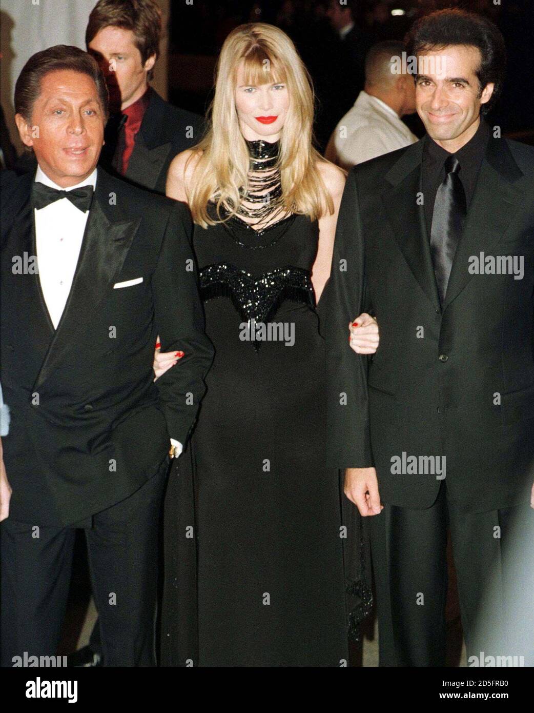 Supermodel Claudia Schiffer (C) poses for photographers with her companion  magician David Copperfield (R) and designer Valentino (L) as the three  arrived at New York's Metropolitan Museum of Art December 8, for