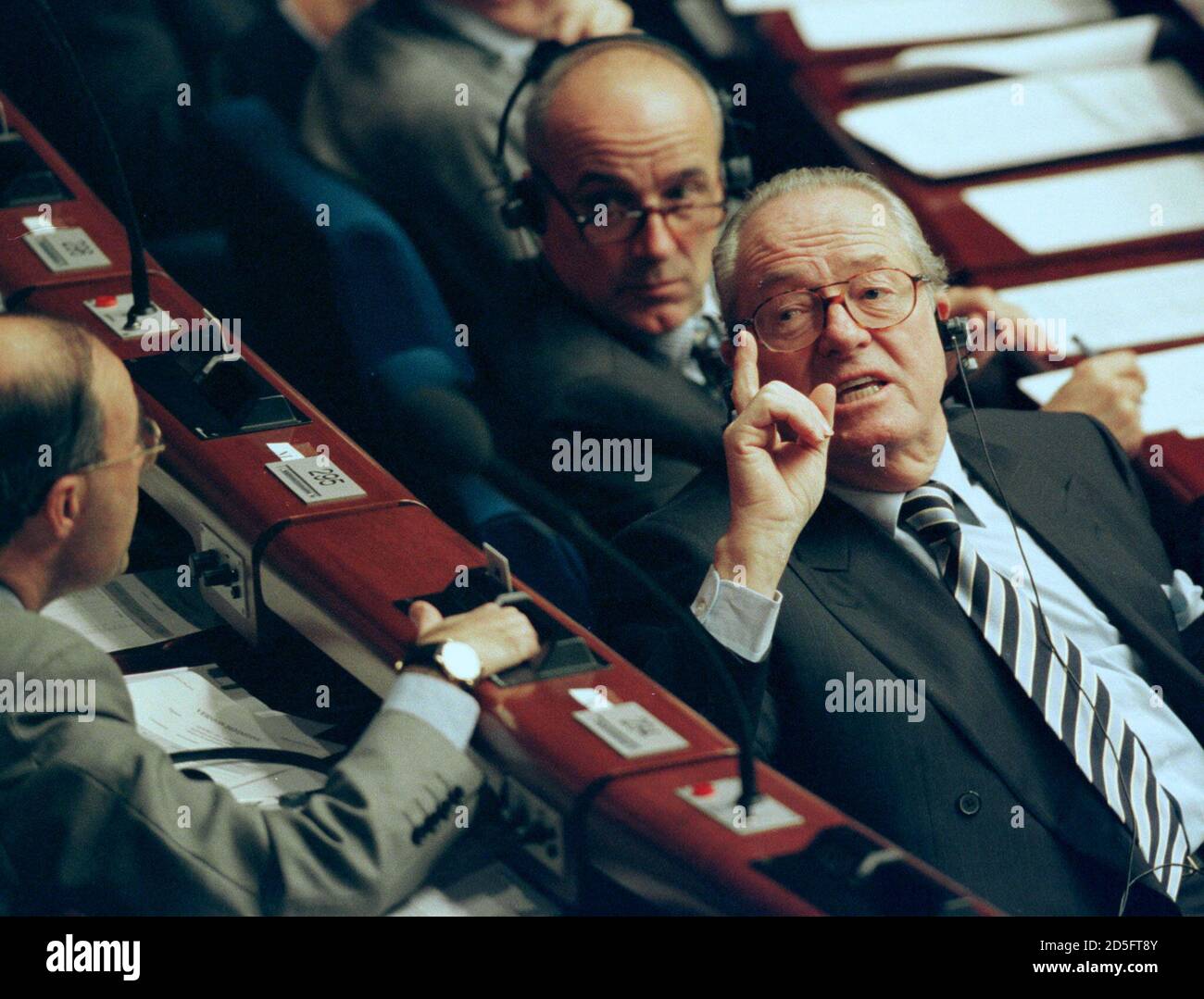 French National Front Party leader Jean-Marie Le Pen (R) turns to speak to  other members of his group at the European Parliament, Fernand Le Rachinel  (C) and Jean-Yves Le Gallou (L) November