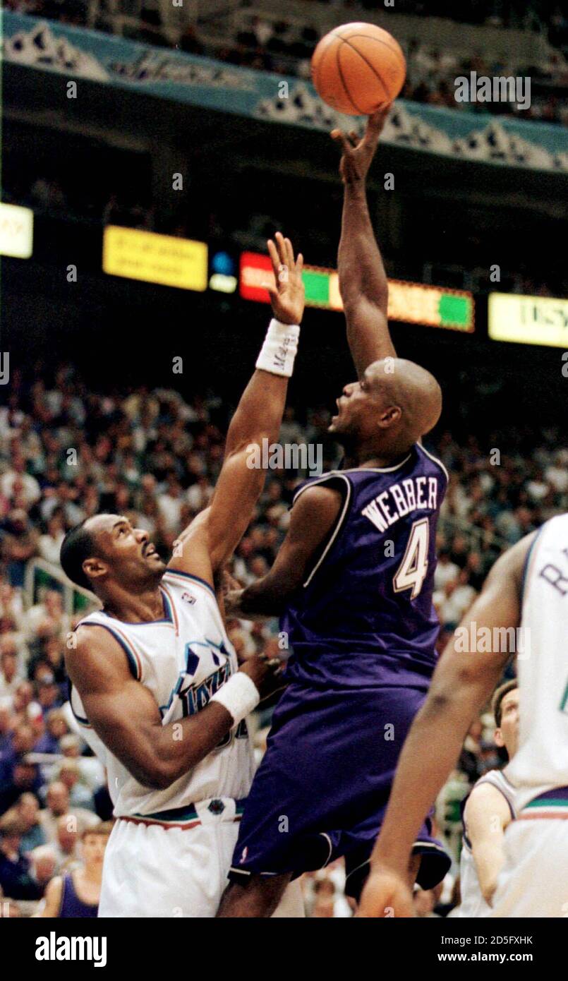 Sacramento Kings forward Chris Weber (R) shoots a hook shot over Utah Jazz  forward Karl Malone during the fourth quarter of their NBA playoff game in  Salt Lake City, May 10. scw/Photo
