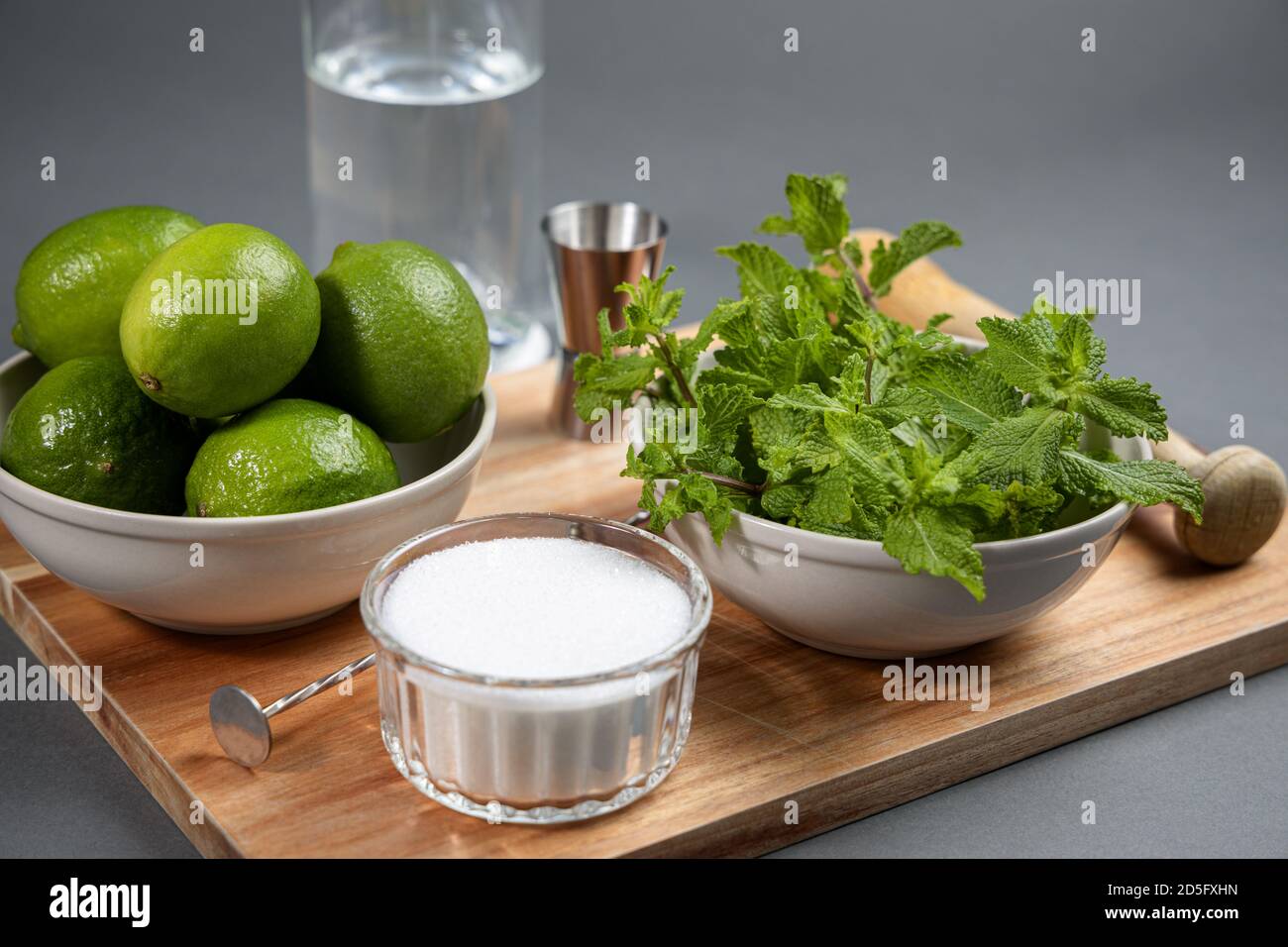 Mojito cocktail ingredients and tools on wooden cutting board Stock Photo