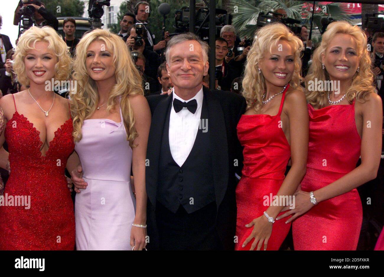 Hugh Hefner (C) founder of Playboy magazine, is escorted by unidentified  models as he arrives for the evening screening at the 52nd Cannes Film  Festival. Hefner returns to Cannes where he will