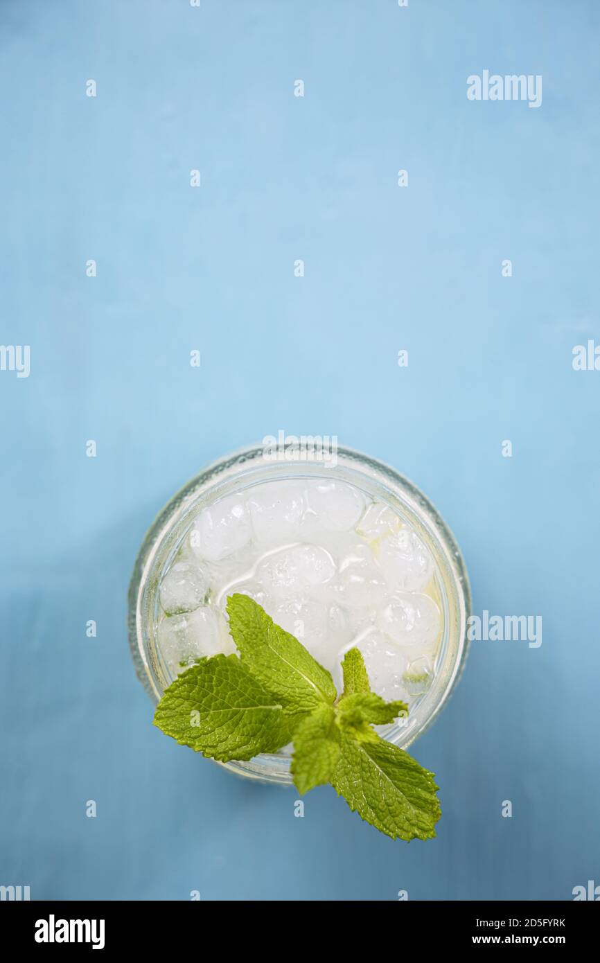 One refreshing mojito cocktail on a blue table. Top view Stock Photo