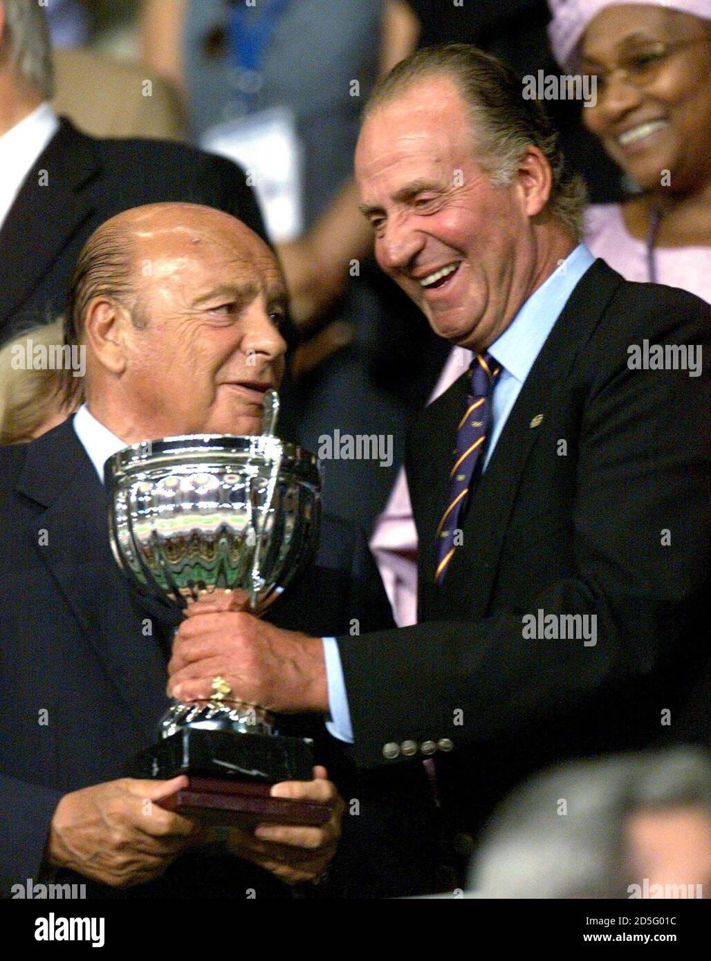 Primo Nebiolo (L) President of the International Amateur Athletics Federation holds the marathon world cup trophy with Spanish King Juan Carlos at the 7th IAAF world championships in athletics in Seville August 29. **DIGITAL IMAGE** Stock Photo