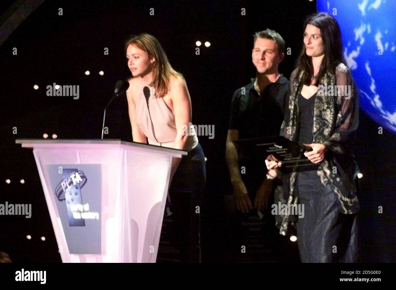 Fashion designer Stella McCartney (at podium) accepts an award for her work on behalf of animal rights along with fellow fashion designer Todd Oldham (C) and model Magali Amadei (R) at the People for the Ethical Treatment of Animals (PETA) Party of the Century and Humanitarian Awards September 18 at Paramount Studios in Hollywood.  [Paul McCartney presented the first Linda McCartney Memorial Award to Pamela Aderson Lee] as a special tribute to his late wife, who fought for animal rights. **DIGITAL IMAGE** Stock Photo