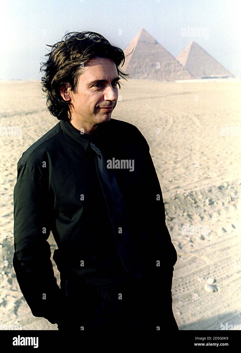 French musician Jean-Michel Jarre poses in front of the 4,500-year-old  pyramids during a photo call September 29. Jarre will help Egypt usher in  the new millennium with a 12-hour electronic opera against
