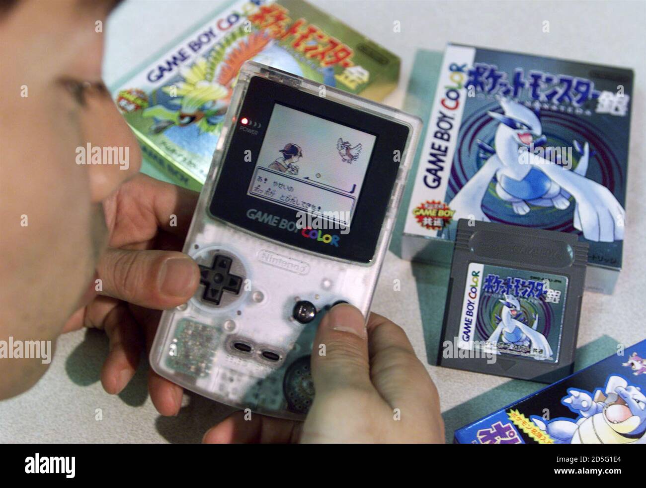 nintendo co employee toru kusakabe displays the game maker s newly launched pokemon or pocket monster video game software pokemon gold left box and pokemon silver right and being demonstrated at nintendo s tokyo office november
