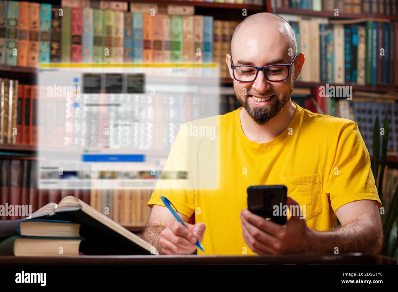 A bearded bald man with glasses and a smile uses a smartphone. Digital transparent window above the phone.In the background-shelves with books. The co Stock Photo