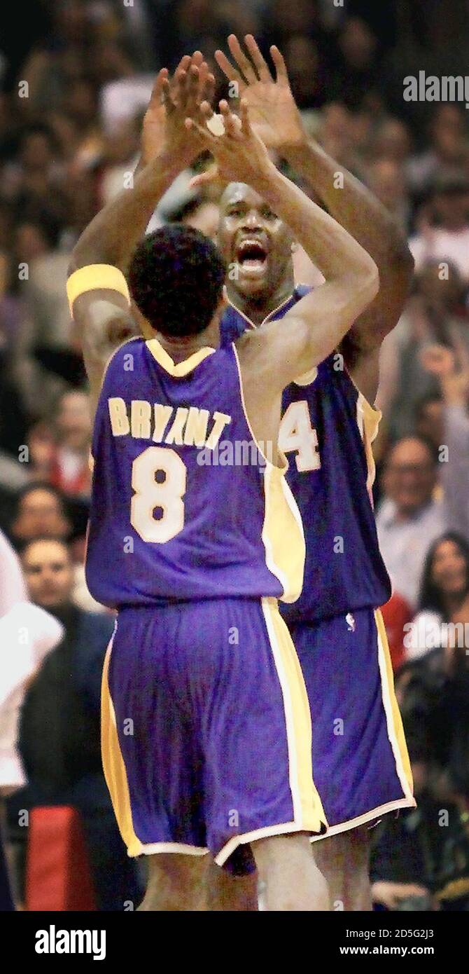 Los Angeles Lakers center Shaquille O'Neal is congratulated by teammate Kobe  Bryant (8) as O'Neal leaves the game in the fourth quarter in the Lakers'  game against the Los Angeles Clippers March