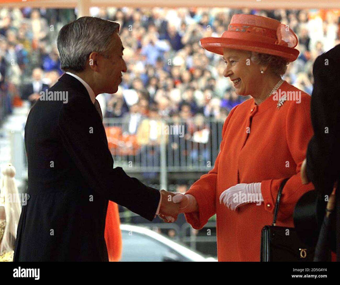 The Queen (R) shakes hands with Japanese Emperor Akihito at the start of his state visit to Britain, May 26. The Emperor faced a protest from hundreds of former Japanese prisoners of War who turned their back on the ceremonial procession as it passed by on its way to Buckingham Palace.  HP/FMS Stock Photo