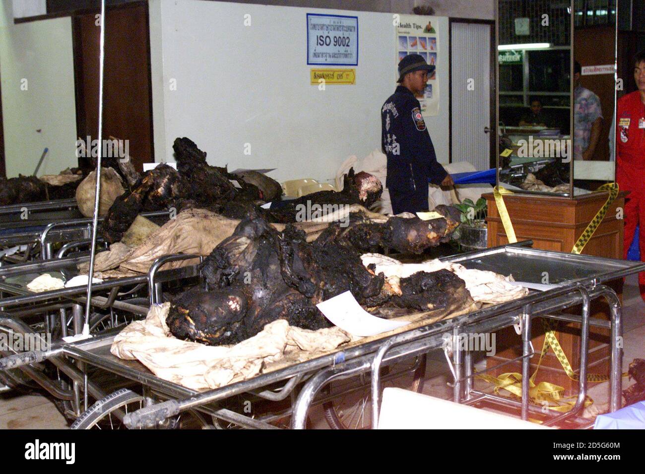 Medics walk among the charred victims of a plane crash in the main hospital of Surat Thani in southern Thailand December 12. Surat Thani hospital officials said rescuers had brought the remains of 67 people who died when the A310-200 crashed in a flooded rubber plantation on its third attempt to make an emergency landing on Friday.    ??» Stock Photo