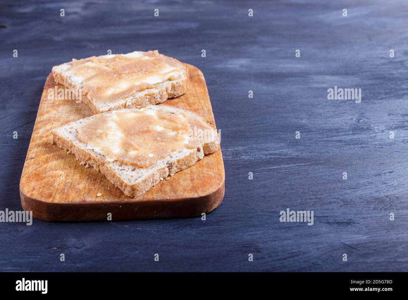 Pollock Roe Bread sandwiches with pollock roe on a wooden kitchen board against black ...