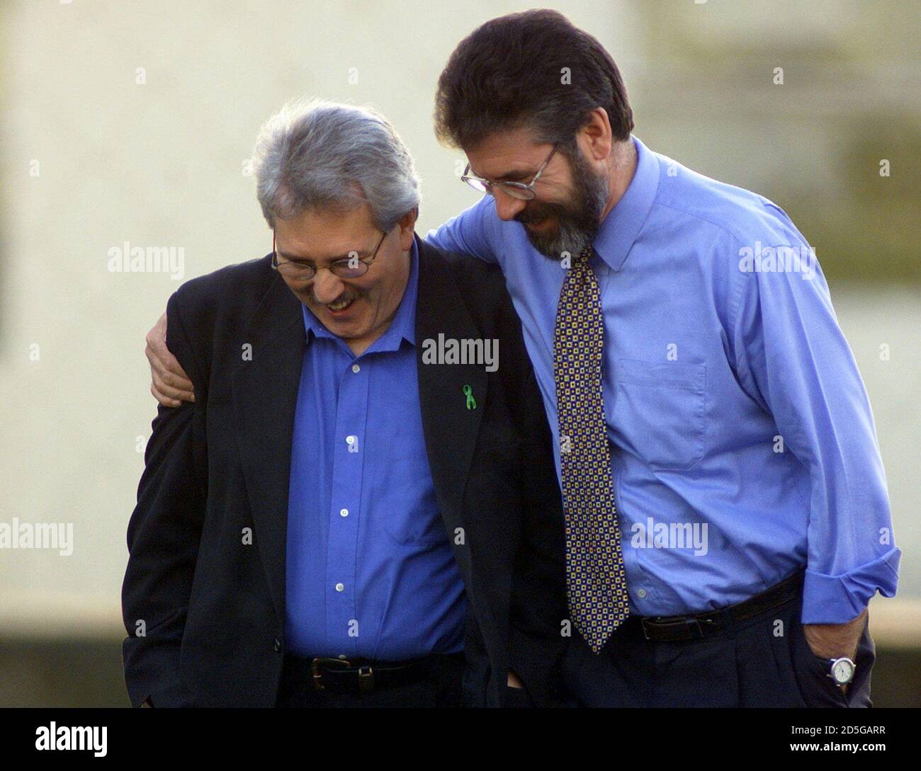 Sinn Fein press officer Richard McAuley (R) gets a hug from Gerry Adams as they walk in the grounds of Stormont Castle November 10. Northern Ireland's rival parties returned to the crucial peace talks amid reports of new overtures aimed at breaking the deadlock over guerrilla disarmament. PM/PS/JP Stock Photo