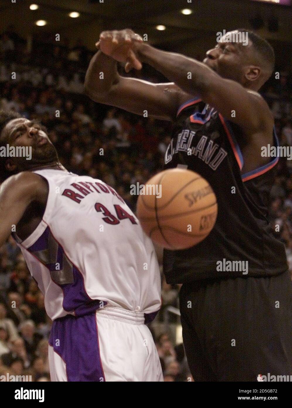 Toronto Raptors Charles Oakley (L) reacts after bumping into Cleveland  Cavaliers Shawn Kemp during second half NBA action december 7. Kemp lost  control of the ball after hitting Oakley. The Raptors defeated