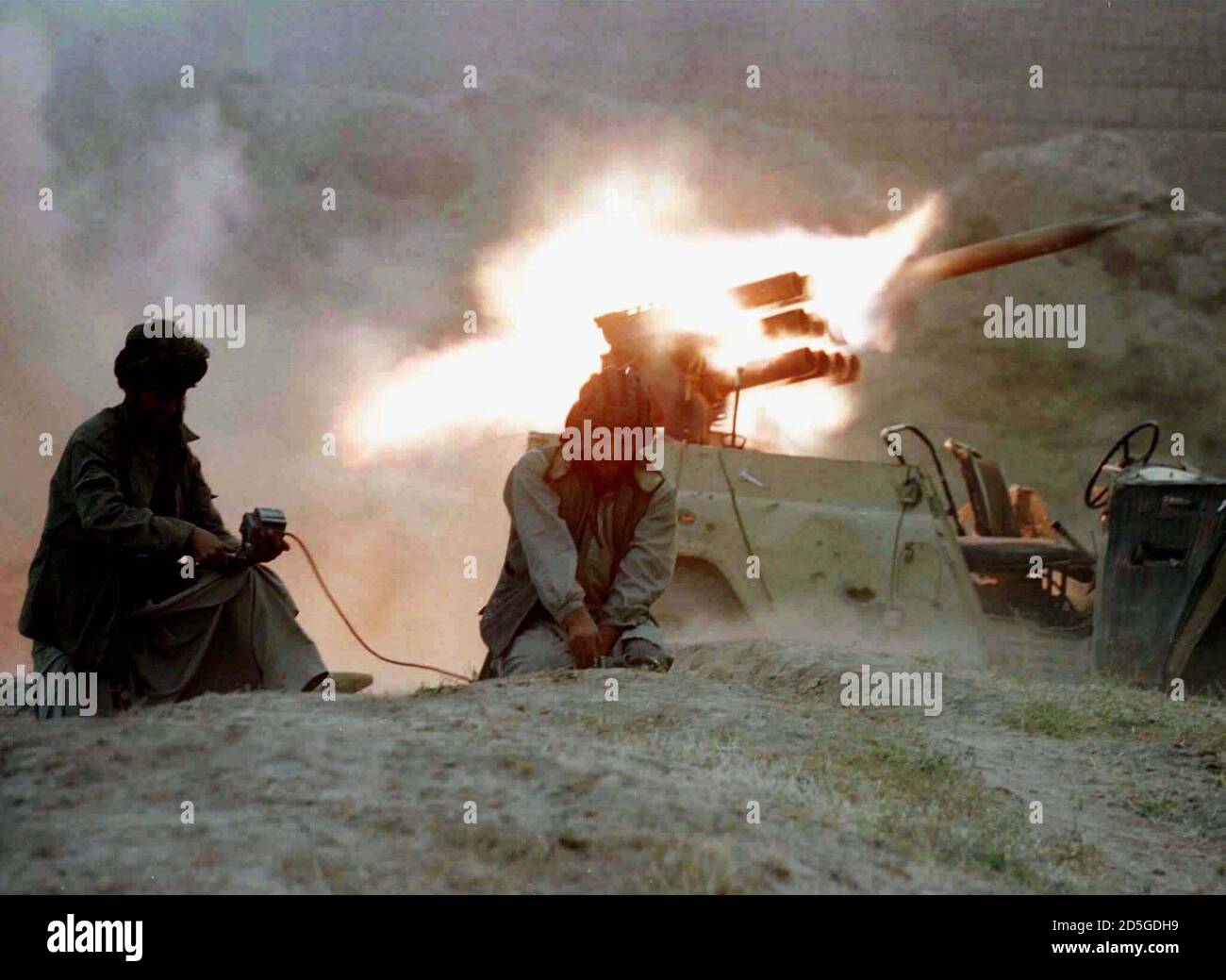 Taliban militia fire a jeep-mounted BM-12 rocket launcher towards a village north of Kabul October 11. Afghan fighters opposing the country's new purist Islamic Taliban rulers cut the main road north of Kabul killing several Taliban militia. Stock Photo