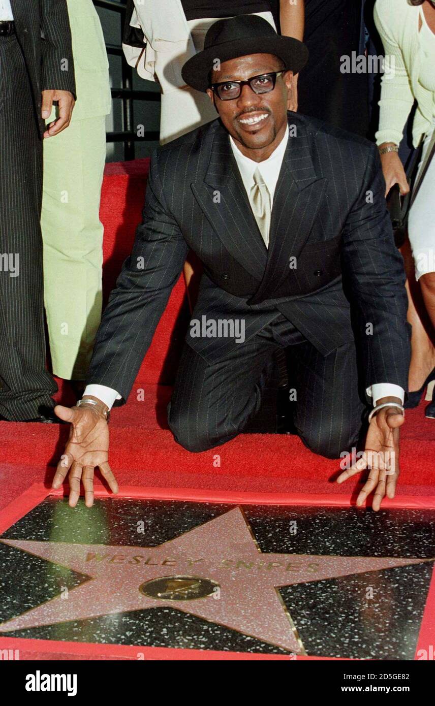 Actor and producer Wesley Snipes poses with his star during ceremonies  honoring him with the 2,114th star on the Walk of Fame in Hollywood August 21. Snipes produced and stars in the action thriller film 'Blade', which opens in the United States  August 21. Stock Photo