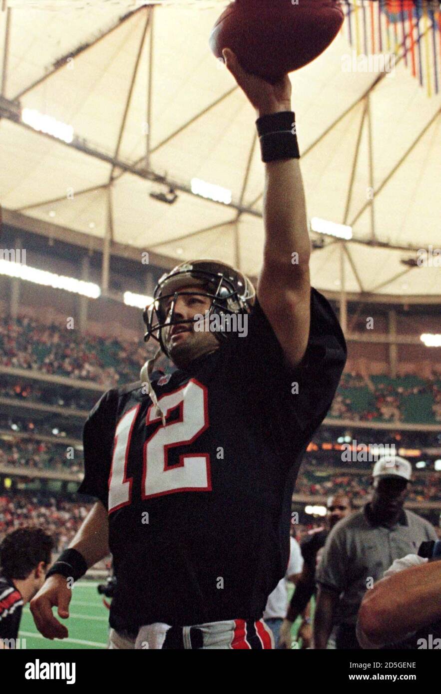 Atlanta Falcons quarterback Chris Chandler holds the ball aloft as he celebrates a 31-19 win and first place in the NFC west division over the San Francisco 49ers, at the end of the game in Atlanta on November 15.  TLC/SB Stock Photo