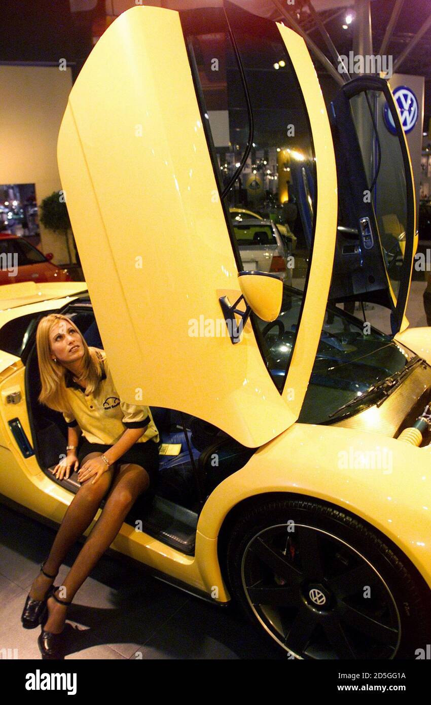 Model Michelle Harrington shows off the Volkswagen "W12" with its "gull  wing" doors folded vertically at the opening of the Melbourne International  Car Show February 26. The four-wheel drive, 420 break horse