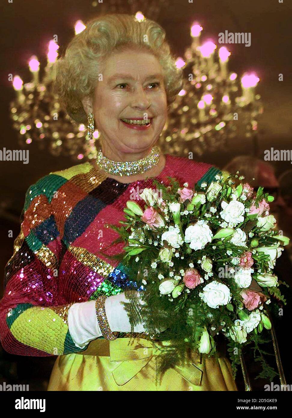 Britain's Queen Elizabeth wearing a brightly coloured harlequin dress arrives at Birmingham Hippodrome for the 1999 Royal Variety Performance November 29. the Queen was entertained during the Charity performance by singing star Charlotte Church and top boy band Westlife.  PS/ME Stock Photo