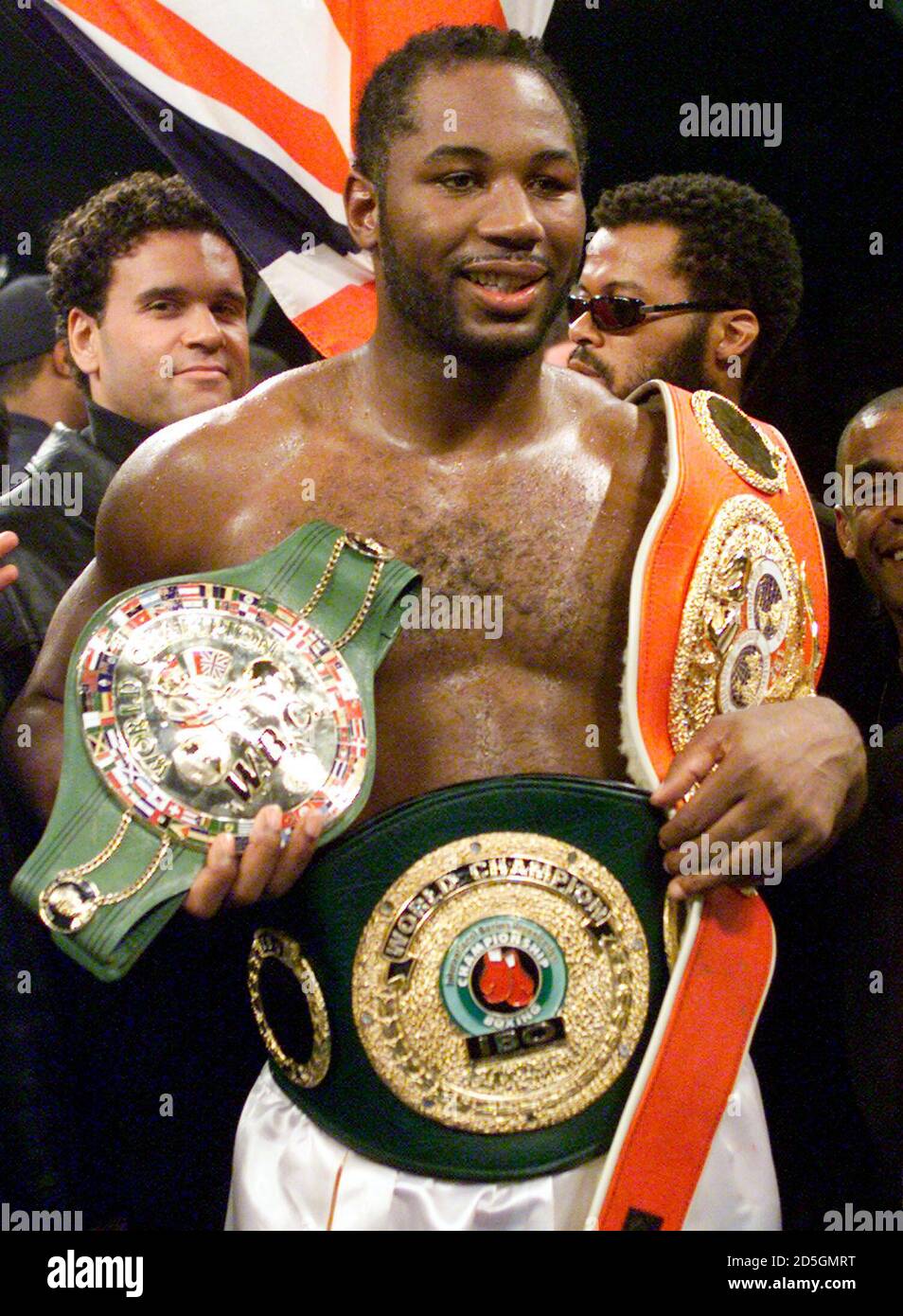 WBC and IBF champion Lennox Lewis of London, England, displays his belts after knocking out challenger Michael Grant of Norristown, Pennsylvania, in the second round of their at Madison Square