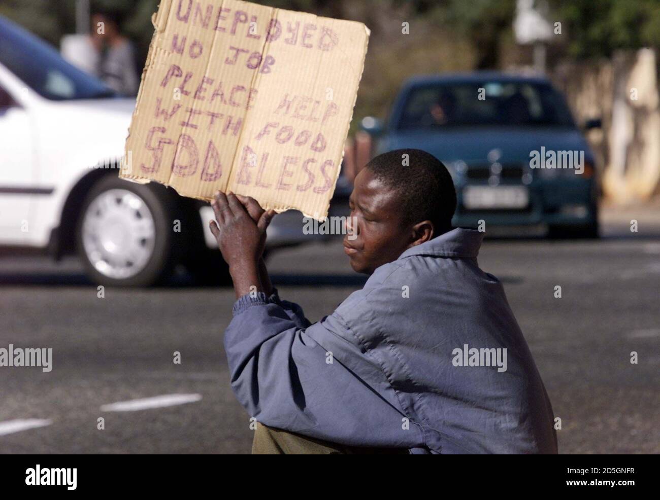 An unemployed black South African pleads for money or food at a Johannesburg street corner July 21. Leaders at the Group of Eight industrialised nations meeting in Okinawa admitted on Friday they must breathe life into a stalled initiative to reduce the debts of the world's poorest countries. But they refused to ease the strict conditions linked to debt relief. Stock Photo