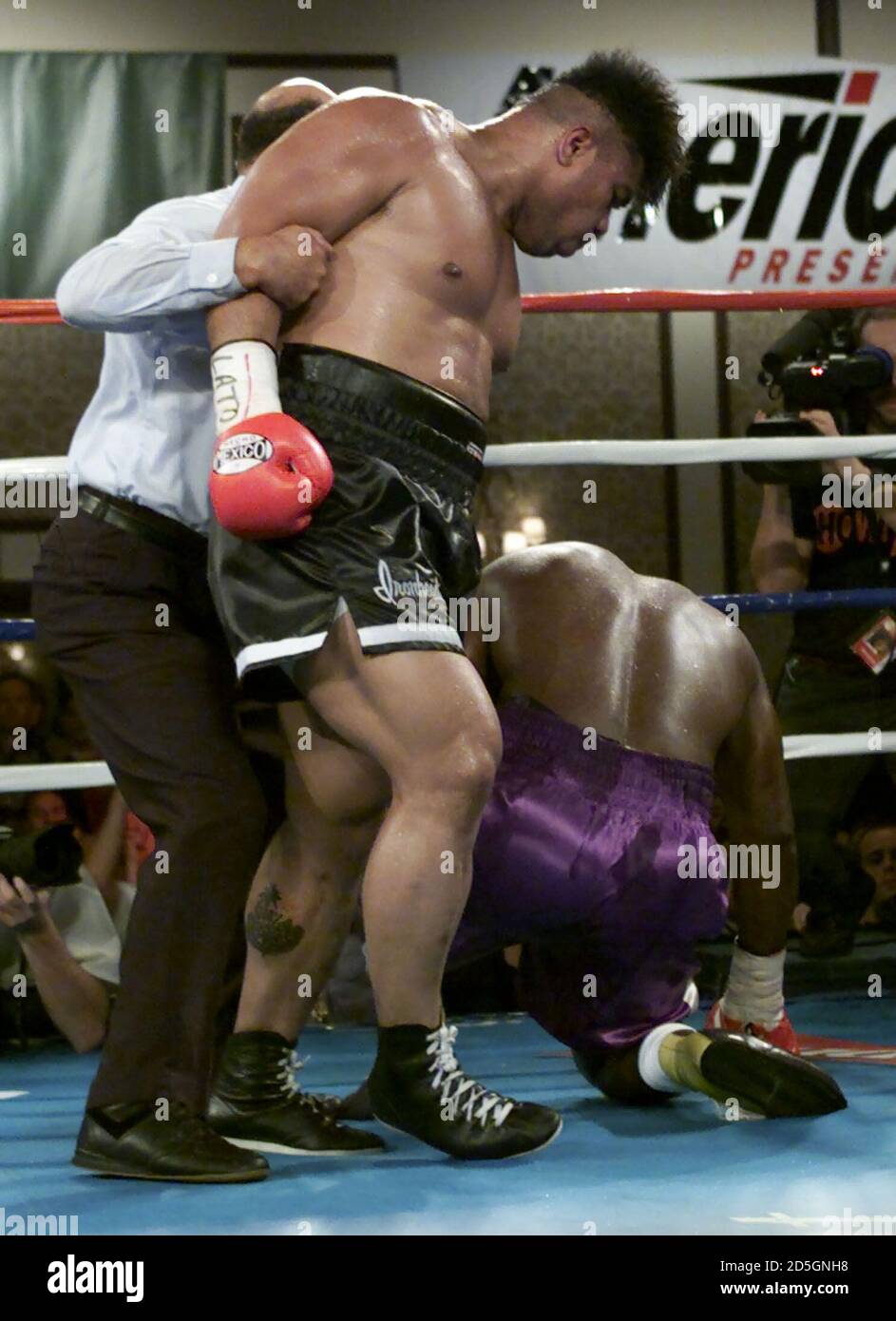 Referee Joe Cortez Restrains Boxer David Tua Of South Auckland New Zealand L After Tua Knocked Out Robert Daniels Of Miami R In The Third Round Of Their Ibf Intercontinental Heavyweight Championship Referee Joe Cortez Restrains Boxer David Tua Of South Auckland New Zealand L After Tua Knocked Out Robert Daniels Of Miami R In The Third Round Of Their Ibf Intercontinental Heavyweight Championship