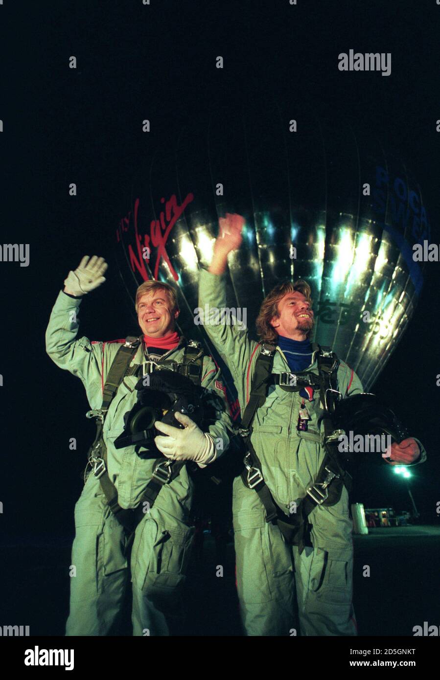 Virgin Atlantic Chairman Richard Branson (R) and co-pilot Per Lindstrand smile and wave to a cheering crowd of 10,000 just before lift-off from Miyakonojo, southern Japan early January 16, 1991 in their attempt to become the first to cross the Pacific Ocean by hot-air balloon. Reuters/Eriko Sugita Stock Photo