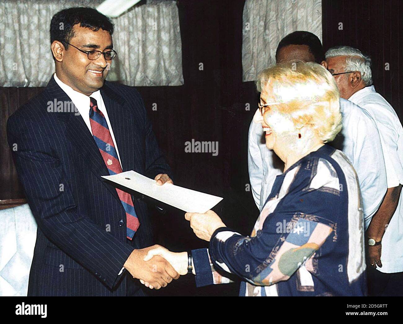 Guyanese President Janet Jagan R Presents Former Finance Minister Bharrat Jagdeo With A Document Confirming His New Post As The Country S New Prime Minister In Georgetown Guyana August 9 Jagan 78 Announced