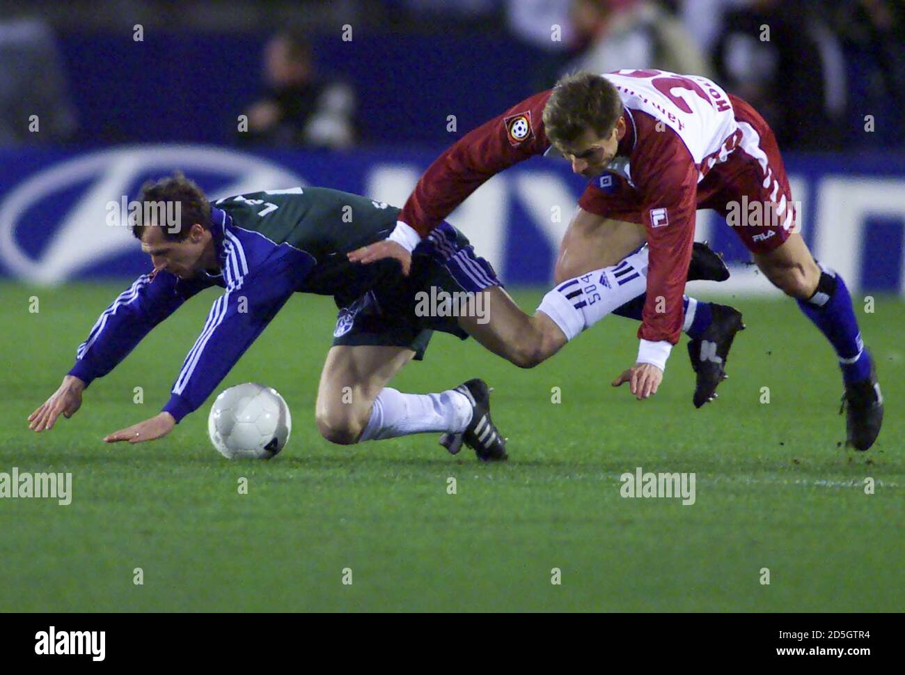 Bernd Hollerbach (R) of the Hamburger Sportverein (HSV) and Radoslav Latal of FC Schalke04 jumps for the ball during their German first league soccer match in Hamburg February 15.  PEM Stock Photo