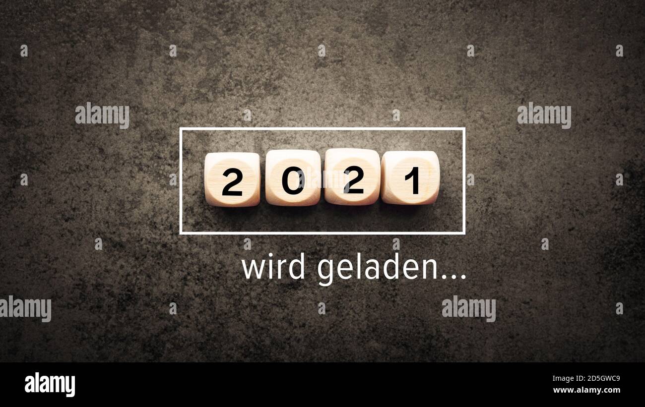 2021 loading in German language on a dark amber background with cubes. Stock Photo