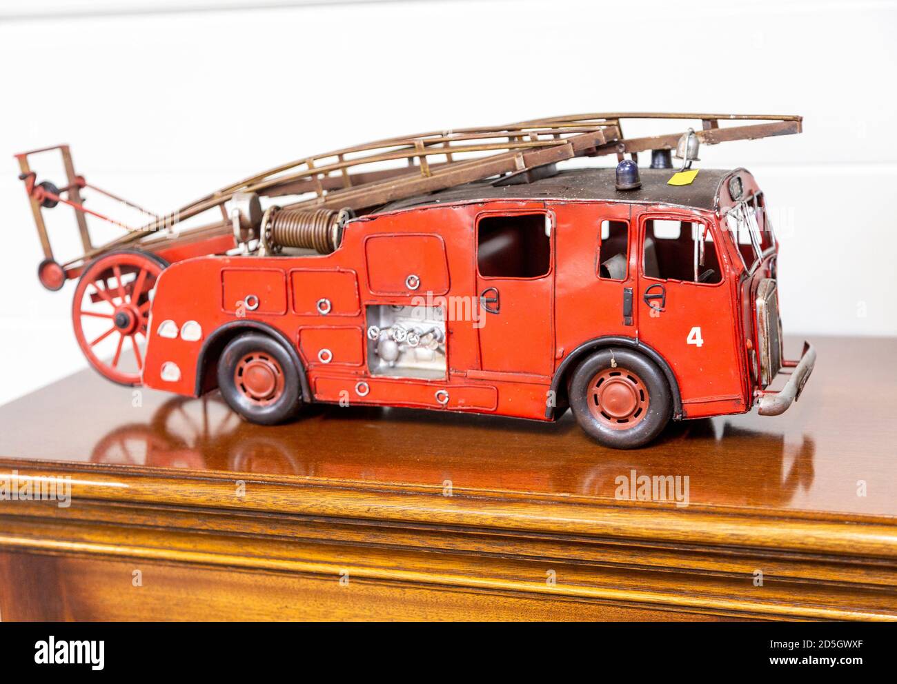 Old red model fire engine on display in house clearance auction sale room, UK Stock Photo
