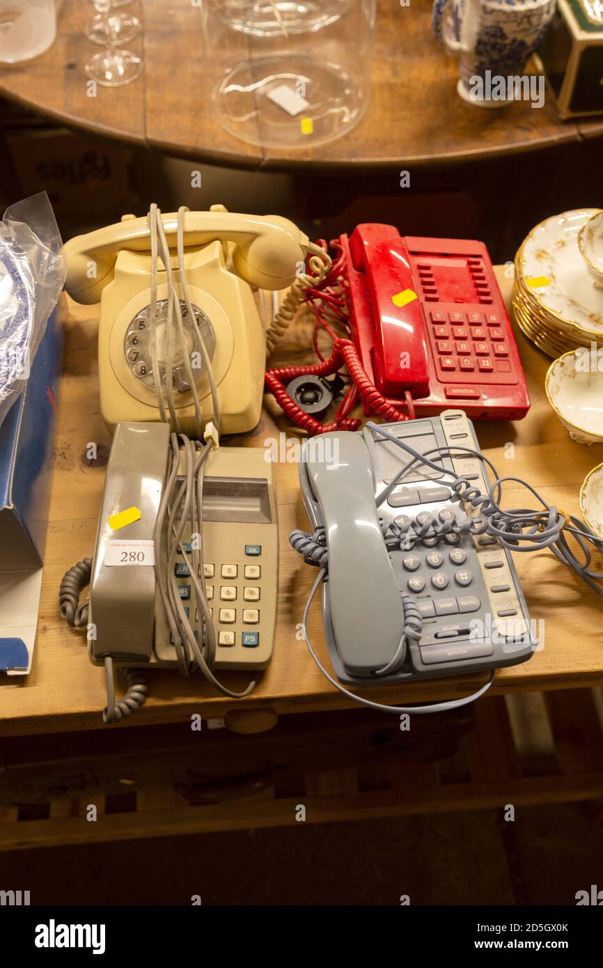 Old telephones on display in house clearance auction sale room, UK Stock Photo