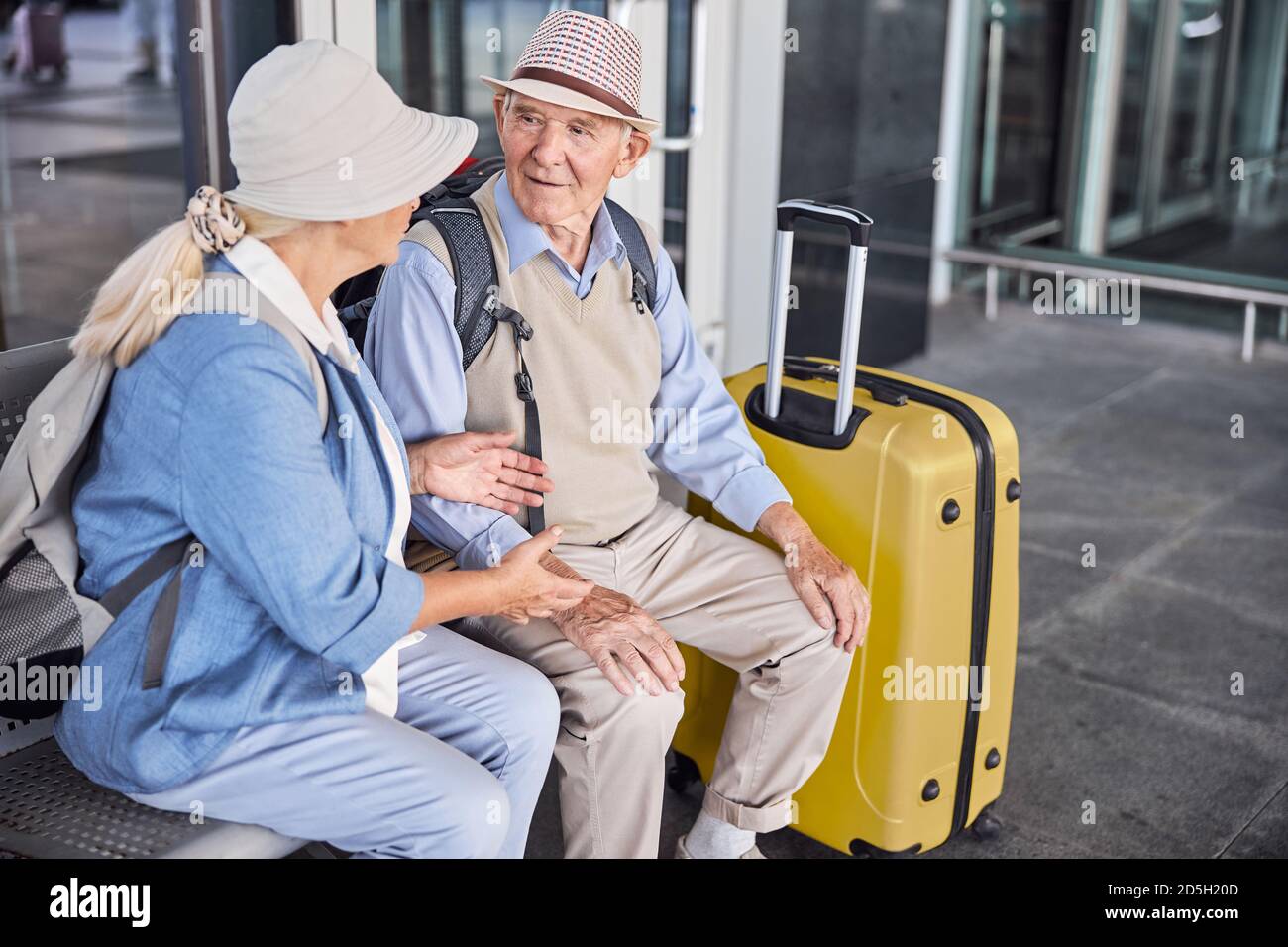 Two senior people having a conversation on the bench Stock Photo