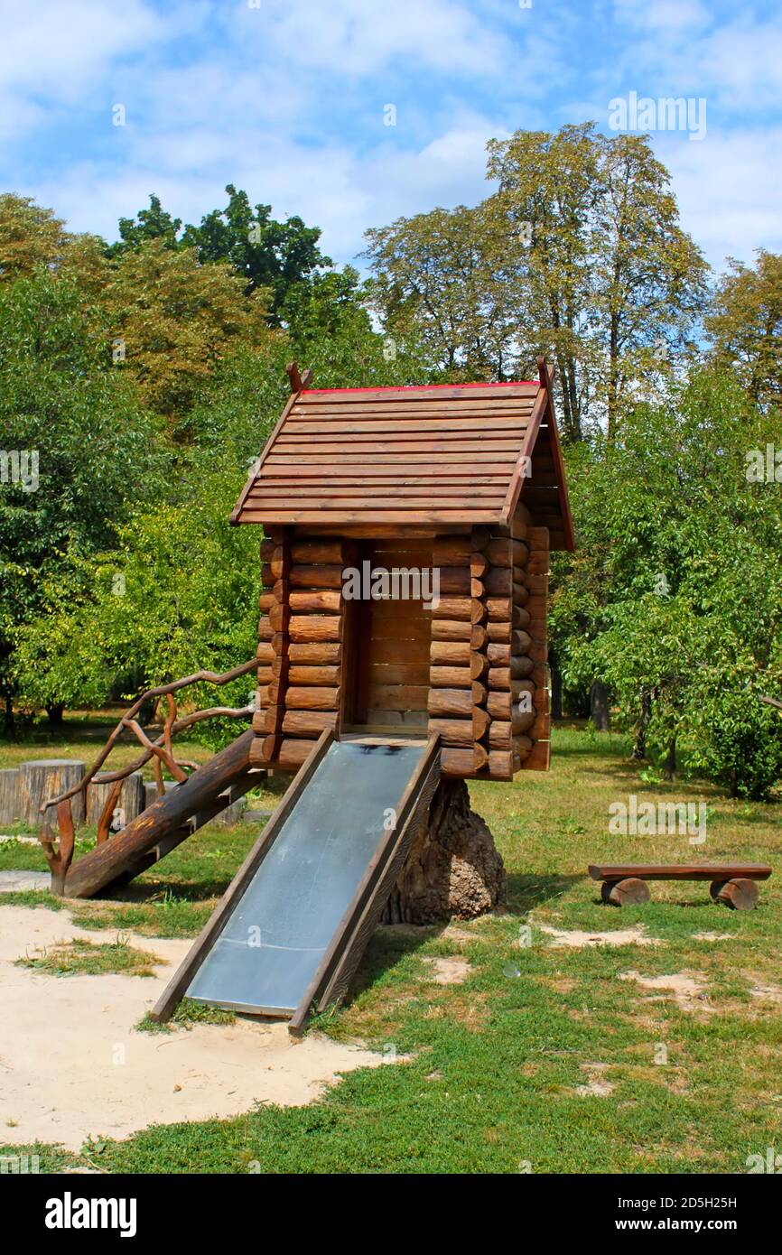 Childrens wooden playhouse with slide Stock Photo Alamy