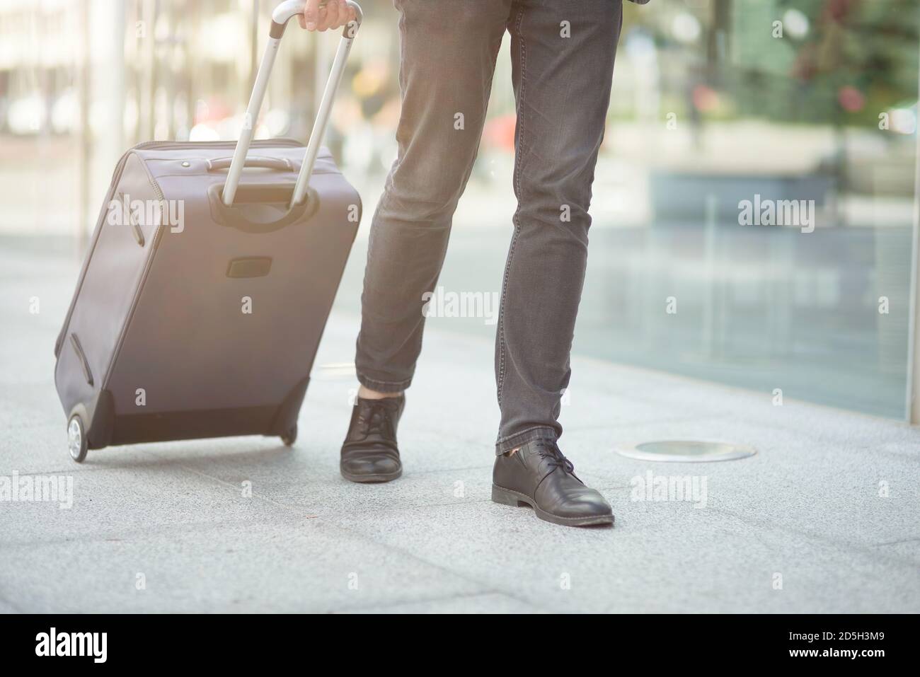 Young businessman after arriving. Comfortable airport, work trip, business  lifestyle. African-american male model with luggage after coming to end  point of his trip. Leaving terminal with documents Stock Photo - Alamy