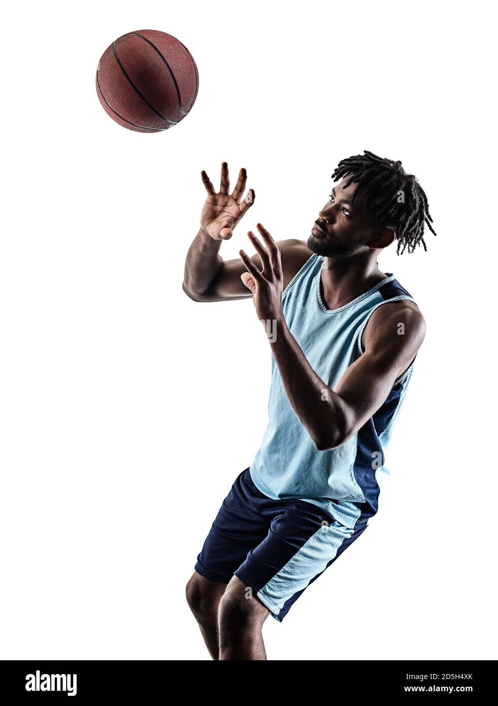 one afro-american african basketball player man isolated in silhouette shadow on white background Stock Photo
