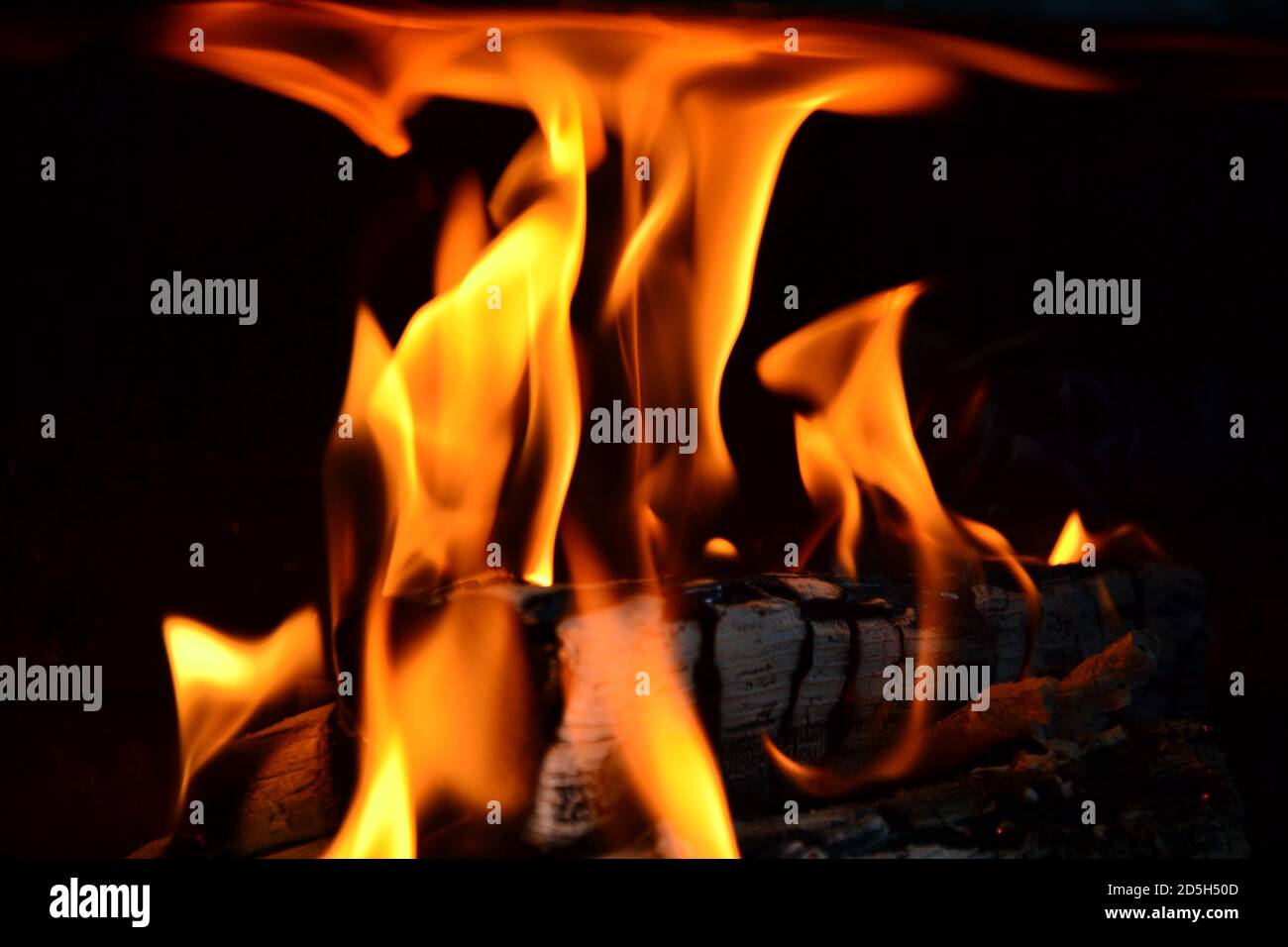 Burning wood, flames from near. Flaring fire in the fireplace. Stock Photo