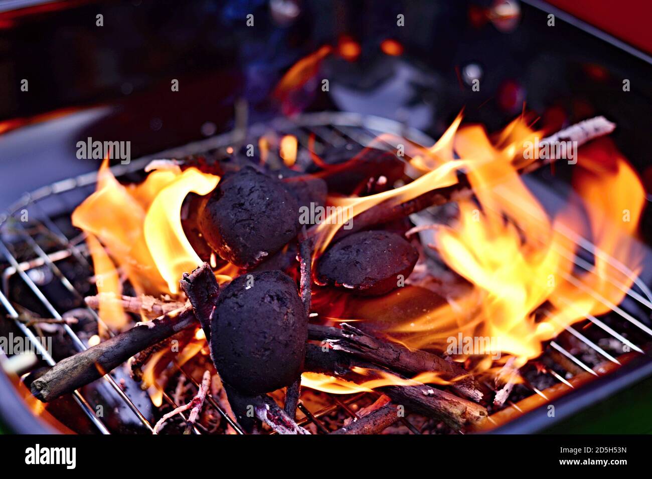 Garden grill with burning wood and charcoal. Summer barbecue in the garden. Stock Photo