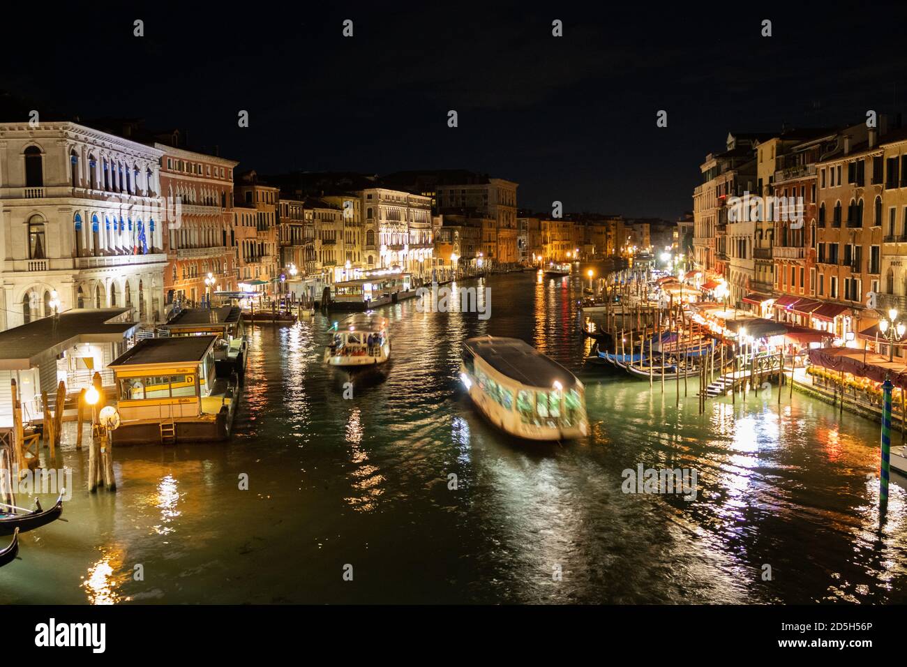 View of the Grand Canal and water taxis sailing on it at night time Stock Photo