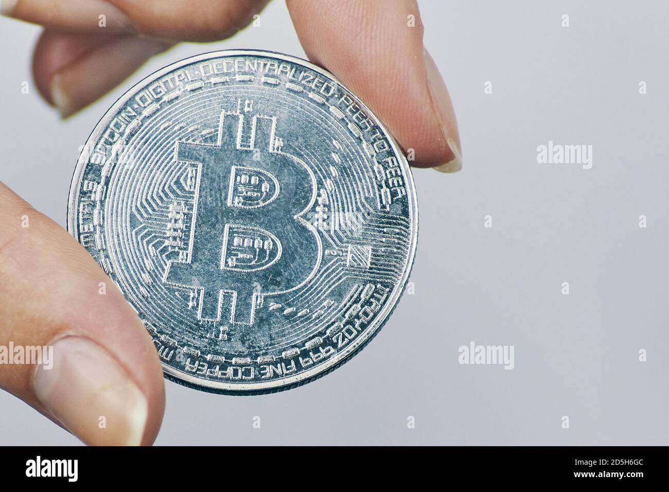 Woman holds Bitcoin coin. Silver coin with bit-coin symbol. Rise of  cryptocurrency. New virtual money concept. Mining or blockchain technology  Stock Photo - Alamy
